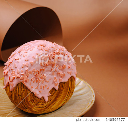 New york roll croissant with pink glaze on plate 140596577