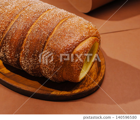 Trdelnik chimney cake on a wooden plate Trdelnik chimney cake on a wooden plate 140596580