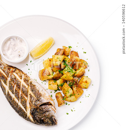 Grilled fish dorado with roasted potatoes and lemon Grilled fish dorado with roasted potatoes and lemon 140596612