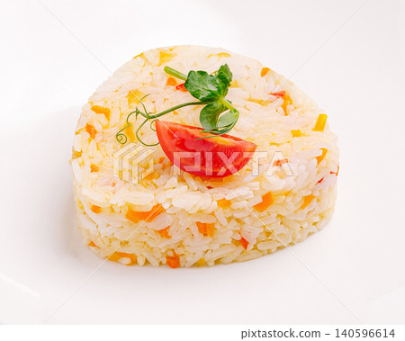 Rice pilaf with carrots and tomato garnish 140596614
