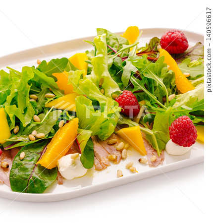 Carpaccio salad with greens, mango, raspberry, pine nuts 140596617