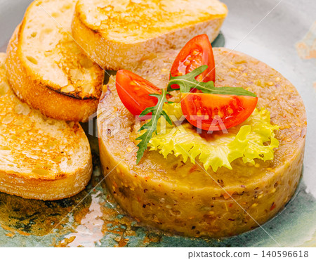 Eggplant caviar spread with toasted bread and cherry tomatoes 140596618