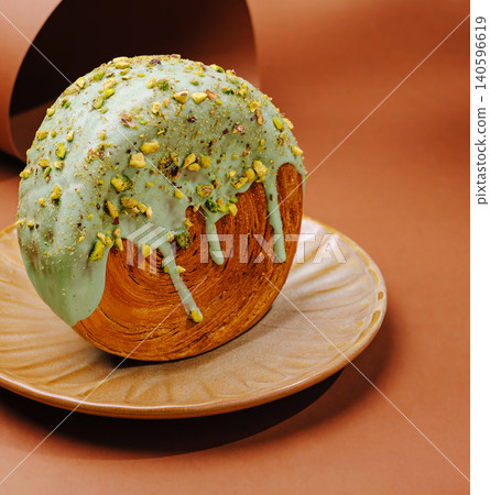 Circular croissant roll with pistachio glazing Circular croissant roll with pistachio glazing 140596619