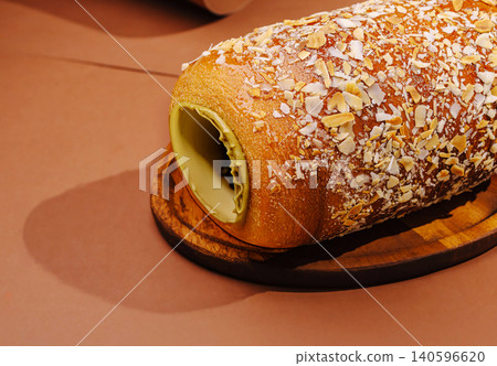Freshly baked chimney cake with pistachio cream and almond flakes 140596620