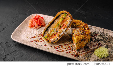 Fried sushi sandwich with salmon and avocado on plate Fried sushi sandwich with salmon and avocado on plate 140596627