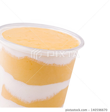 Layered mango and yogurt smoothie in cup Layered mango and yogurt smoothie in cup 140596670