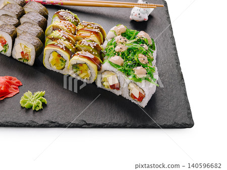 Assortment of fresh sushi rolls served on slate board Assortment of fresh sushi rolls served on slate board 140596682