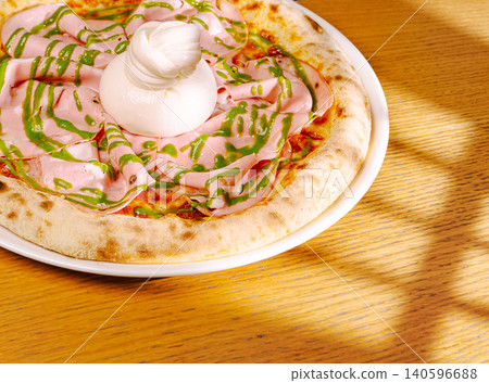 Pizza with mortadella, burrata, and pistacchio pesto Pizza with mortadella, burrata, and pistacchio pesto 140596688