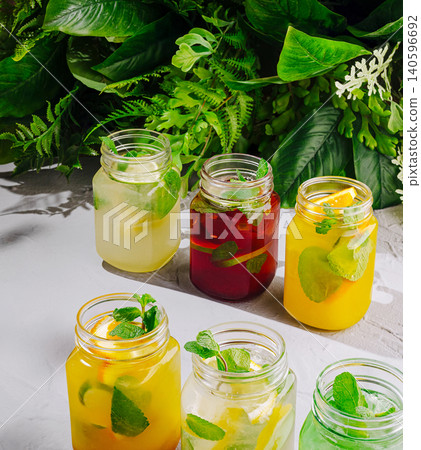 Refreshing summer drinks with citrus and mint in jars Refreshing summer drinks with citrus and mint in jars 140596692