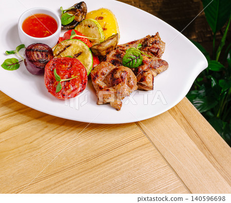 Grilled pork and roasted vegetables with chili sauce Grilled pork and roasted vegetables with chili sauce 140596698