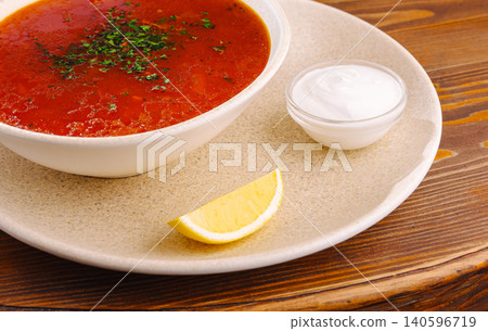 Ukrainian borscht soup with sour cream and lemon 140596719
