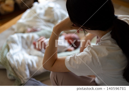 A young mother exhausted from childcare A young mother exhausted from childcare 140596781
