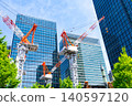 Large cranes and skyscrapers at a construction site 140597120