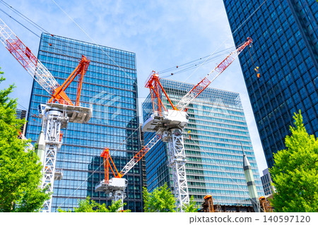 Large cranes and skyscrapers at a construction site Large cranes and skyscrapers at a construction site 140597120