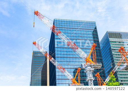Large cranes and skyscrapers at a construction site Large cranes and skyscrapers at a construction site 140597122