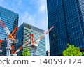 Large cranes and skyscrapers at a construction site 140597124