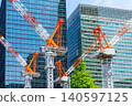 Large cranes and skyscrapers at a construction site 140597125