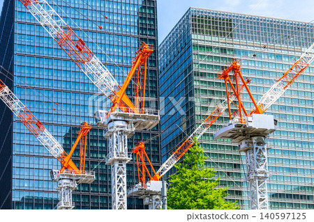 Large cranes and skyscrapers at a construction site Large cranes and skyscrapers at a construction site 140597125