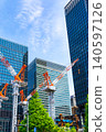 Large cranes and skyscrapers at a construction site 140597126