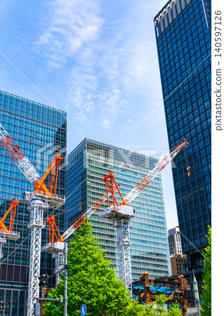Large cranes and skyscrapers at a construction site Large cranes and skyscrapers at a construction site 140597126