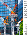 Large cranes and skyscrapers at a construction site 140597127