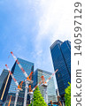 Large cranes and skyscrapers at a construction site 140597129