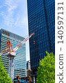 Large cranes and skyscrapers at a construction site 140597131