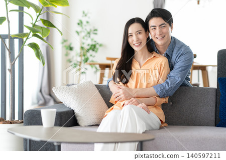A middle-aged couple relaxing in the living room A middle-aged couple relaxing in the living room 140597211