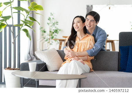A middle-aged couple relaxing in the living room A middle-aged couple relaxing in the living room 140597212