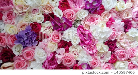 Bright flowers cover a wall in a display of various colors and types during a celebration in a public space in the afternoon Bright flowers cover a wall in a display of various colors and types during a celebration in a public space in the afternoon 140597406