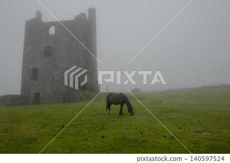 tmospheric misty moorland view with Cornish engine house. 140597524