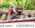 A Shisa statue perched on the red tiled roof of an old house in Onna Village, Okinawa. 140598038