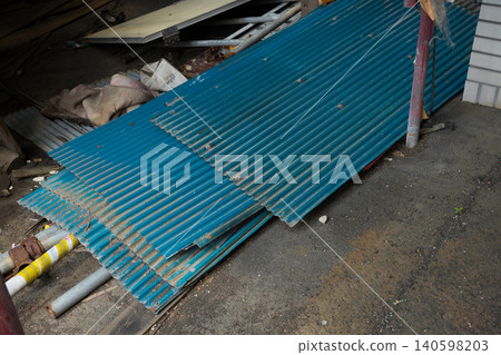 The blue corrugated iron sheet that was placed down The blue corrugated iron sheet that was placed down 140598203