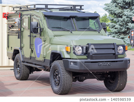 Military vehicle parks on a street during a public event to showcase its features and capabilities for visitors Military vehicle parks on a street during a public event to showcase its features and capabilities for visitors 140598539