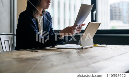 A woman checking documents in the office A woman checking documents in the office 140598622