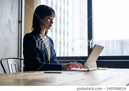 woman working on a tablet woman working on a tablet 140598624