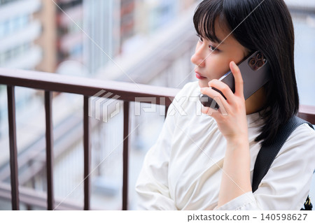 A young woman talking on her smartphone A young woman talking on her smartphone 140598627