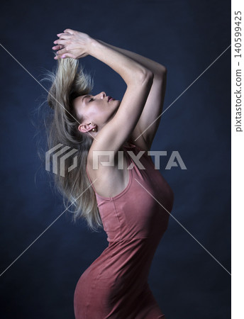 portrait of a young attractive woman on a dark background portrait of a young attractive woman on a dark background 140599425