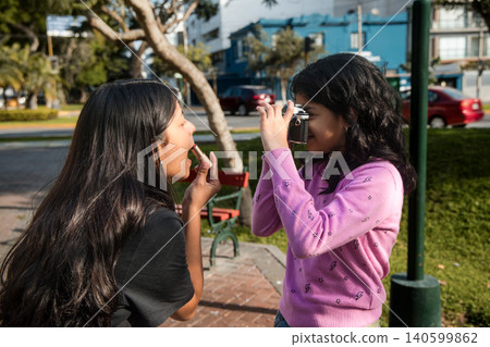 Two girls are taking a picture of each other Two girls are taking a picture of each other 140599862