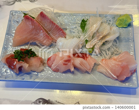 A platter of fresh sashimi, including squid and yellowtail, specialties of Tsushima, Nagasaki Prefecture. 140600001