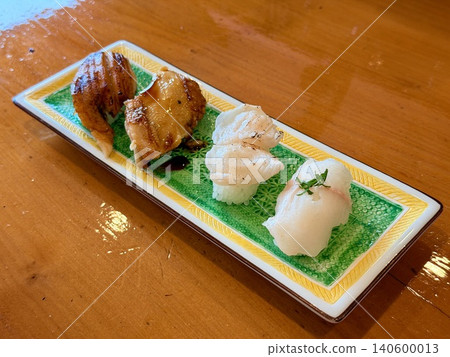 Nigiri sushi featuring raw or seared conger eel, a specialty of Tsushima Island in Nagasaki Prefecture. Nigiri sushi featuring raw or seared conger eel, a specialty of Tsushima Island in Nagasaki Prefecture. 140600013