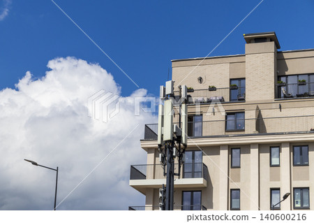 Cellular base station antennas installed next to a modern apartment building Cellular base station antennas installed next to a modern apartment building 140600216
