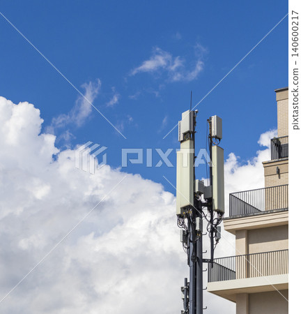 Cellular base station antennas installed next to a modern apartment building Cellular base station antennas installed next to a modern apartment building 140600217