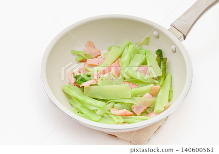 Sautéed stem lettuce and bacon in a frying pan Sautéed stem lettuce and bacon in a frying pan 140600561