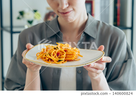 A young woman struggling to decide on pasta A young woman struggling to decide on pasta 140600824