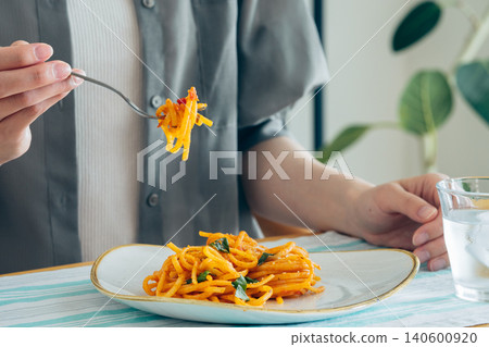 A young woman eating pasta for lunch 140600920