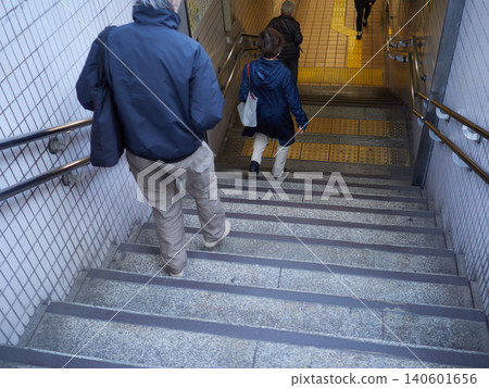 People descending the stairs of a subway station. People descending the stairs of a subway station. 140601656
