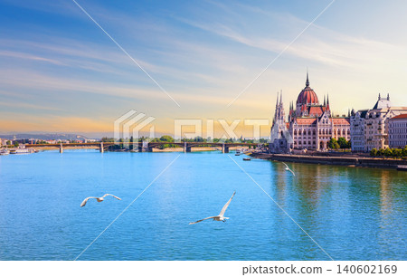 Romantic sunset over Budapest Parliament with flying seagulls and Danube river bridges, Hungary Romantic sunset over Budapest Parliament with flying seagulls and Danube river bridges, Hungary 140602169