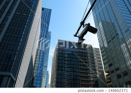 A cluster of modern skyscrapers, their glass exteriors reflecting each other. A cluster of modern skyscrapers, their glass exteriors reflecting each other. 140602371