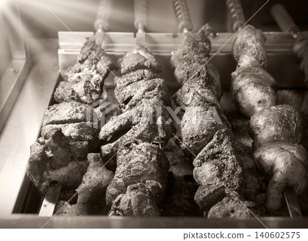 A ruddy kebab is being grilled on a barbecue A ruddy kebab is being grilled on a barbecue 140602575